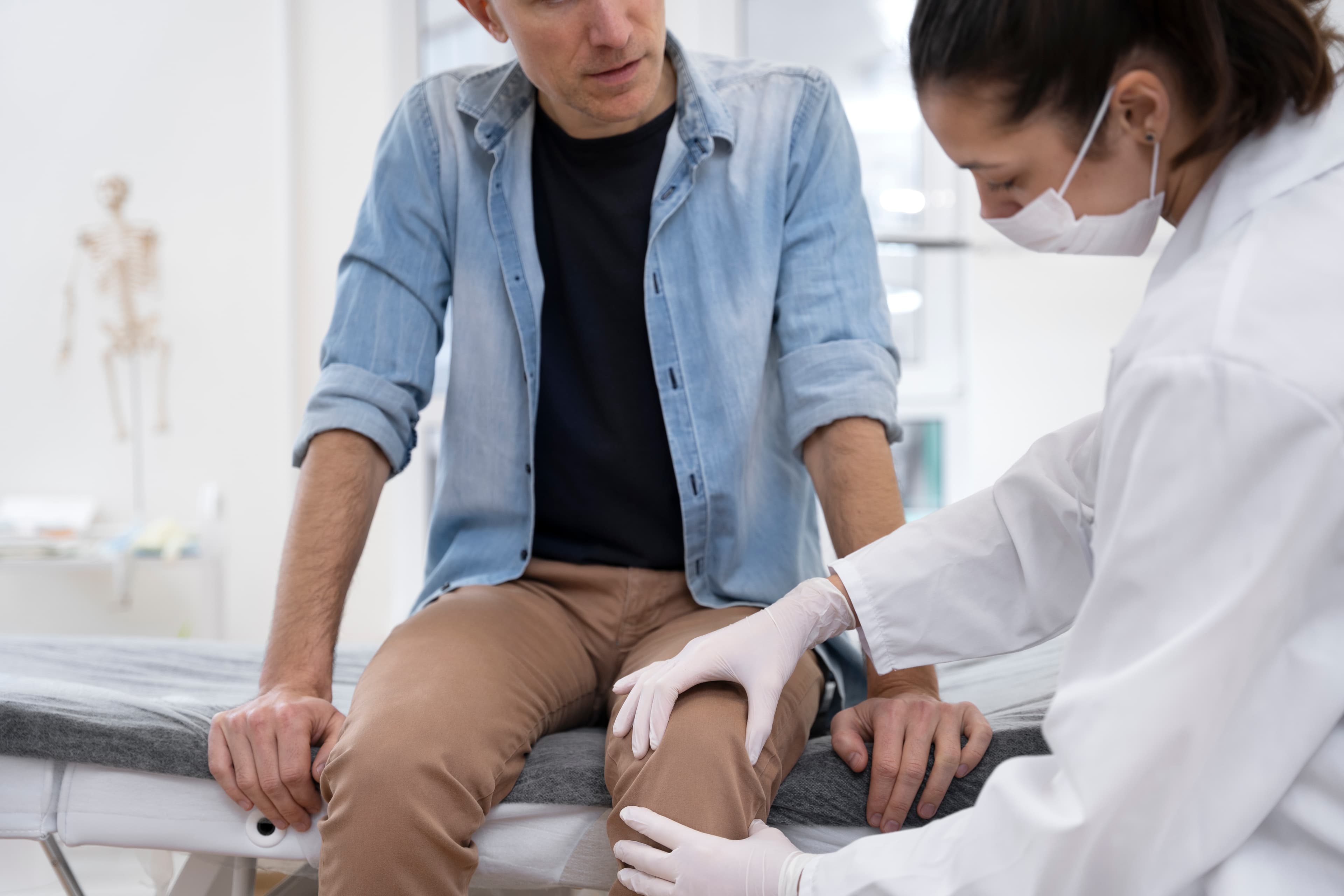 Orthopedic surgeon checking a patient's knee before replacement surgery